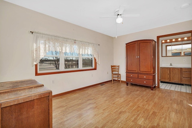 unfurnished bedroom with ceiling fan, light wood-type flooring, and sink