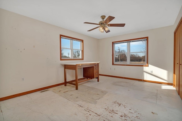 unfurnished room featuring ceiling fan and plenty of natural light