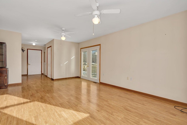 empty room with ceiling fan, light hardwood / wood-style floors, and french doors