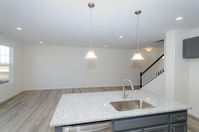 kitchen featuring dishwasher, decorative light fixtures, gray cabinetry, and sink