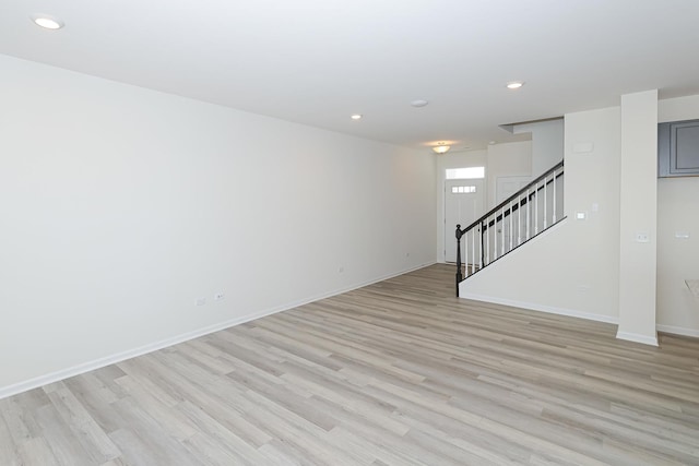 empty room with light hardwood / wood-style flooring