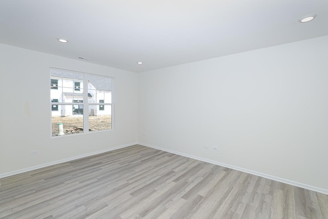 spare room featuring light hardwood / wood-style flooring