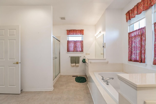 bathroom with separate shower and tub, plenty of natural light, and tile patterned floors