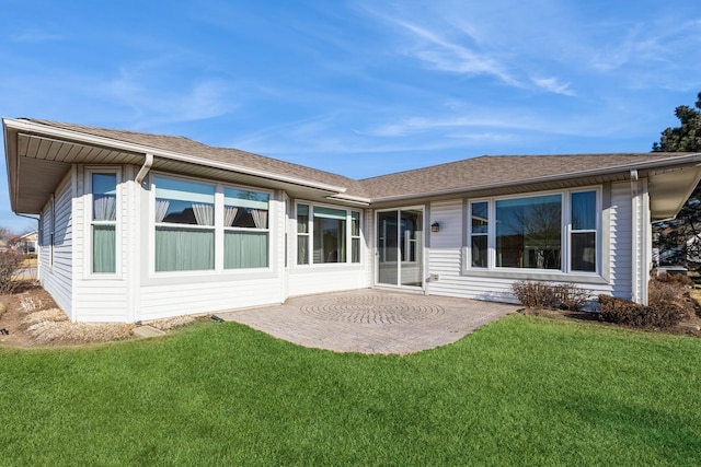 rear view of property with a lawn and a patio