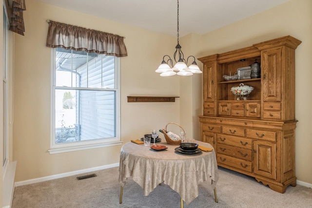 carpeted dining area featuring a wealth of natural light and a notable chandelier