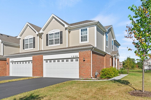 view of front of home featuring a garage and a front lawn