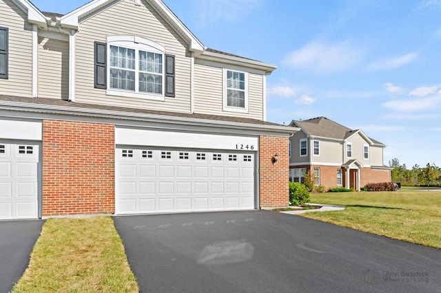 view of front property with a garage and a front yard