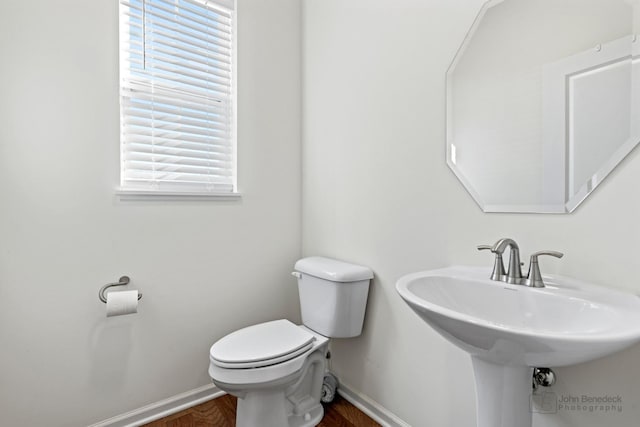 bathroom featuring hardwood / wood-style floors, plenty of natural light, toilet, and sink