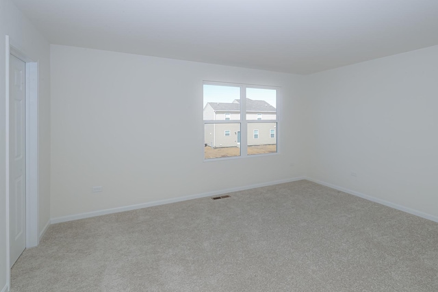 unfurnished room with light carpet