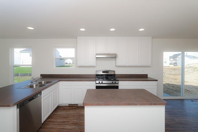 kitchen featuring a wealth of natural light, sink, white cabinets, and appliances with stainless steel finishes