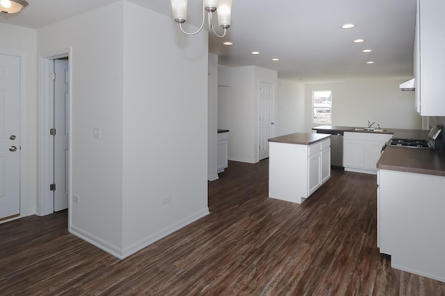 kitchen featuring white cabinetry, dark wood-type flooring, exhaust hood, and sink