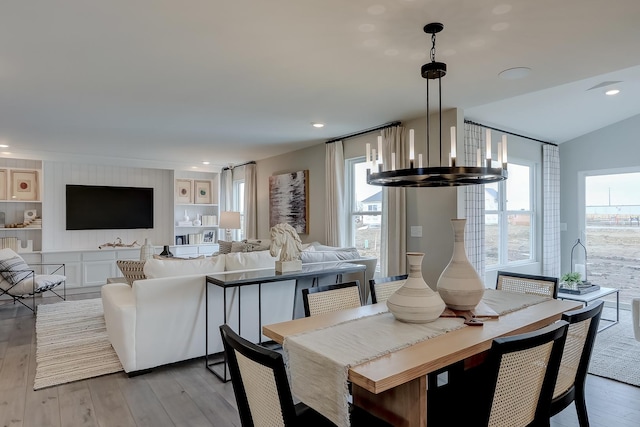 dining room with light hardwood / wood-style flooring, a chandelier, and plenty of natural light