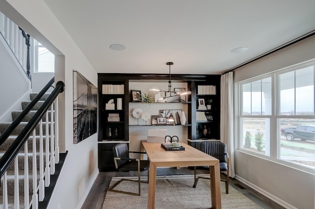 office space featuring a wealth of natural light, a chandelier, and hardwood / wood-style flooring