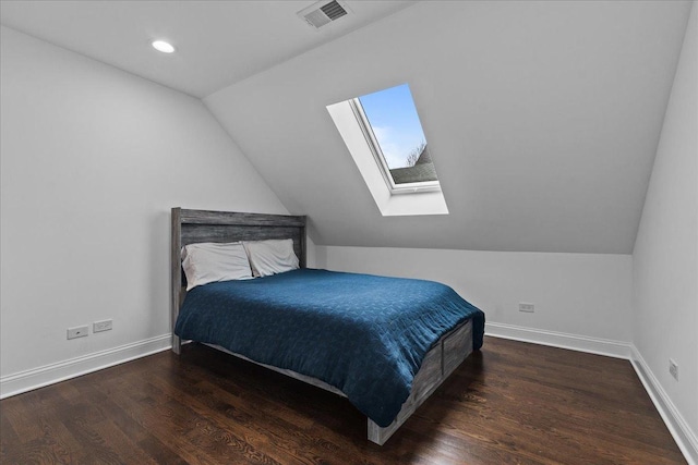 bedroom with vaulted ceiling and dark wood-type flooring