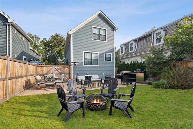 back of property with a patio area, a fire pit, and a lawn