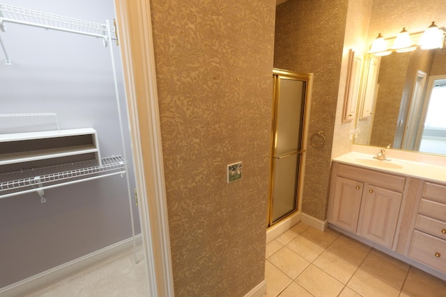 bathroom featuring tile patterned floors, walk in shower, and vanity