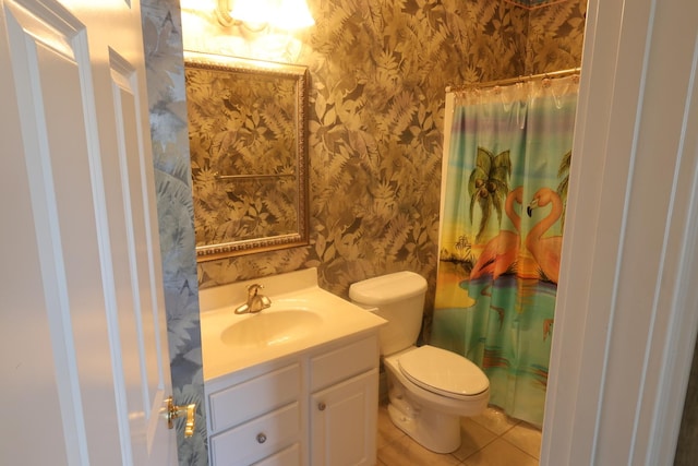 bathroom featuring toilet, vanity, tile patterned flooring, and walk in shower