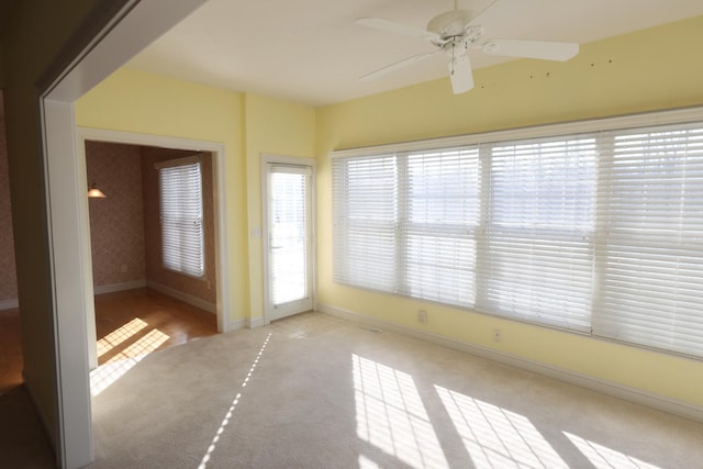 carpeted empty room featuring ceiling fan