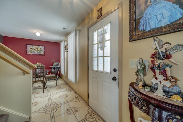 entryway with light tile patterned floors