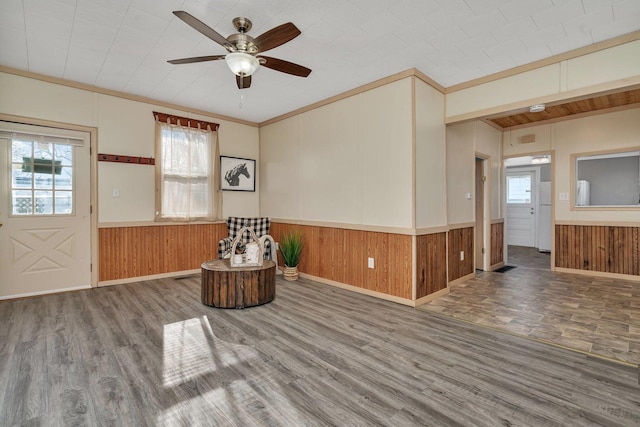 interior space with hardwood / wood-style floors, ceiling fan, and crown molding