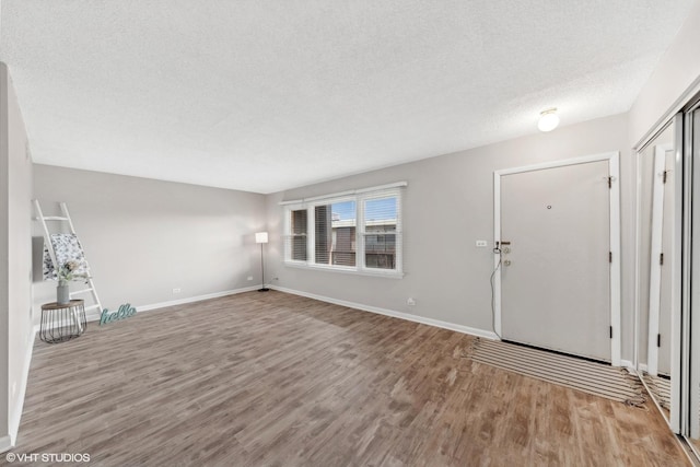 foyer featuring a textured ceiling and light hardwood / wood-style flooring