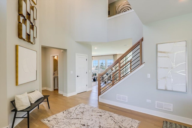 entrance foyer with light hardwood / wood-style flooring and a high ceiling