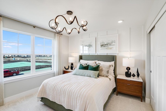 carpeted bedroom with a notable chandelier