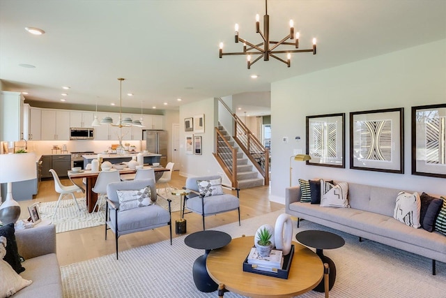 living room featuring light wood-type flooring and a notable chandelier