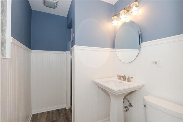 bathroom featuring wood-type flooring and toilet