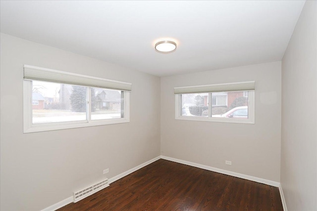 spare room with dark hardwood / wood-style floors