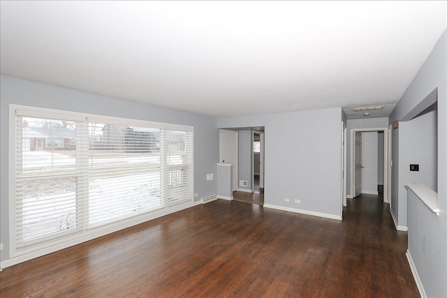 spare room with dark hardwood / wood-style floors