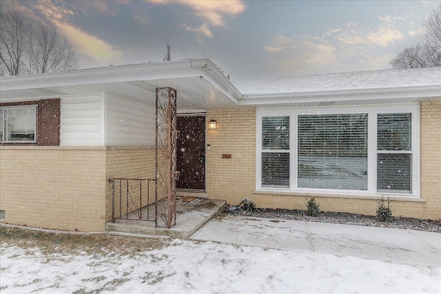 view of snow covered property entrance