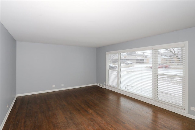 empty room with dark wood-type flooring