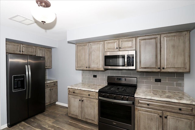 kitchen with stainless steel appliances, dark wood-type flooring, and backsplash