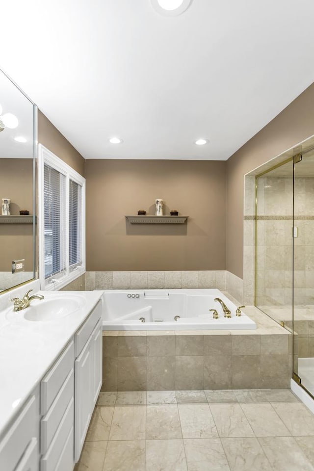 bathroom featuring separate shower and tub and vanity