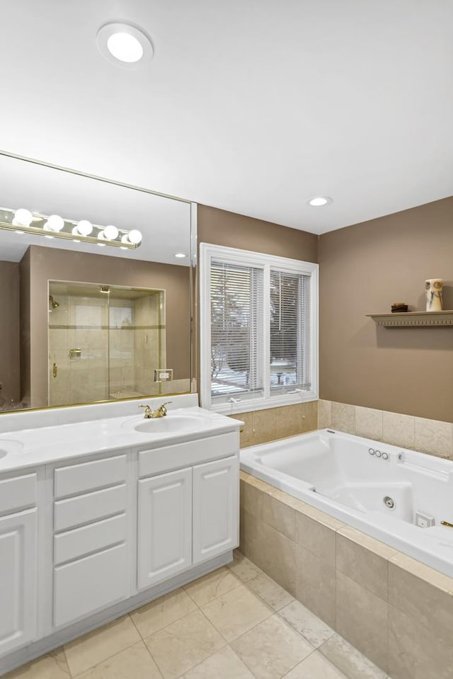 bathroom with independent shower and bath, tile patterned flooring, and vanity