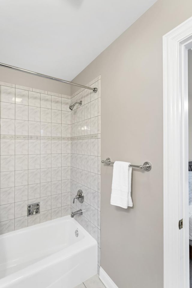 bathroom featuring tile patterned floors and tiled shower / bath combo