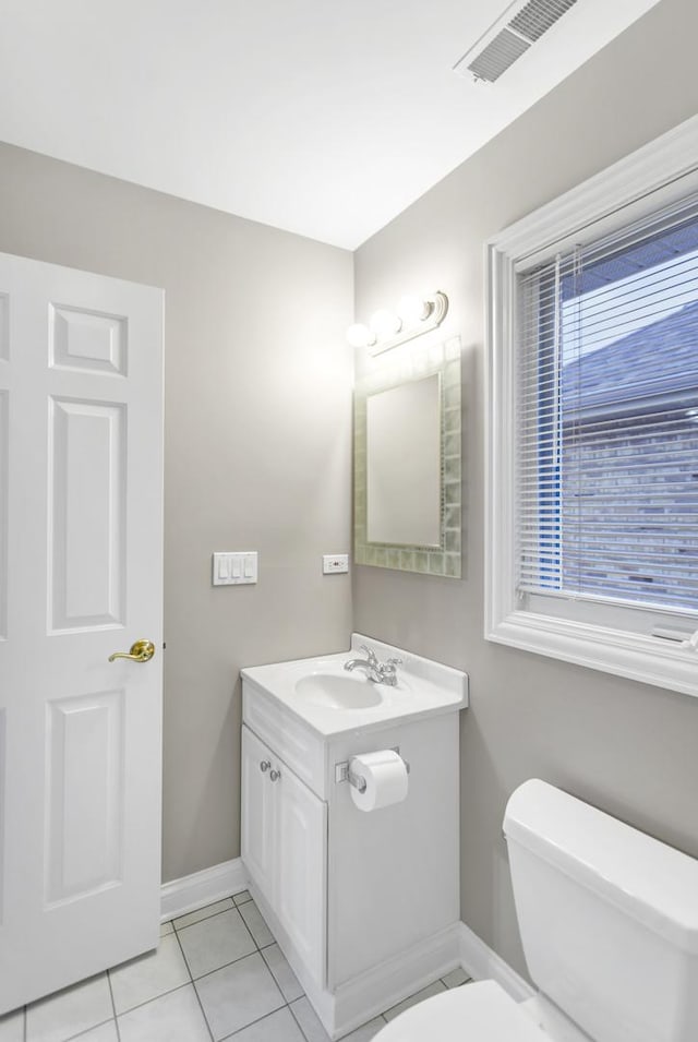 bathroom with toilet, tile patterned flooring, and vanity