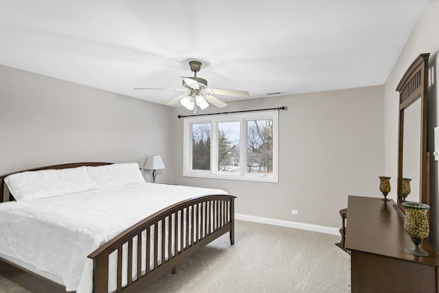 bedroom with ceiling fan and light colored carpet