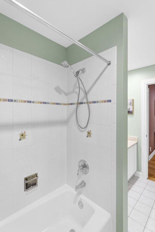 bathroom with vanity, tiled shower / bath, and tile patterned flooring