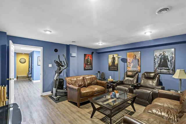 home theater room featuring hardwood / wood-style flooring