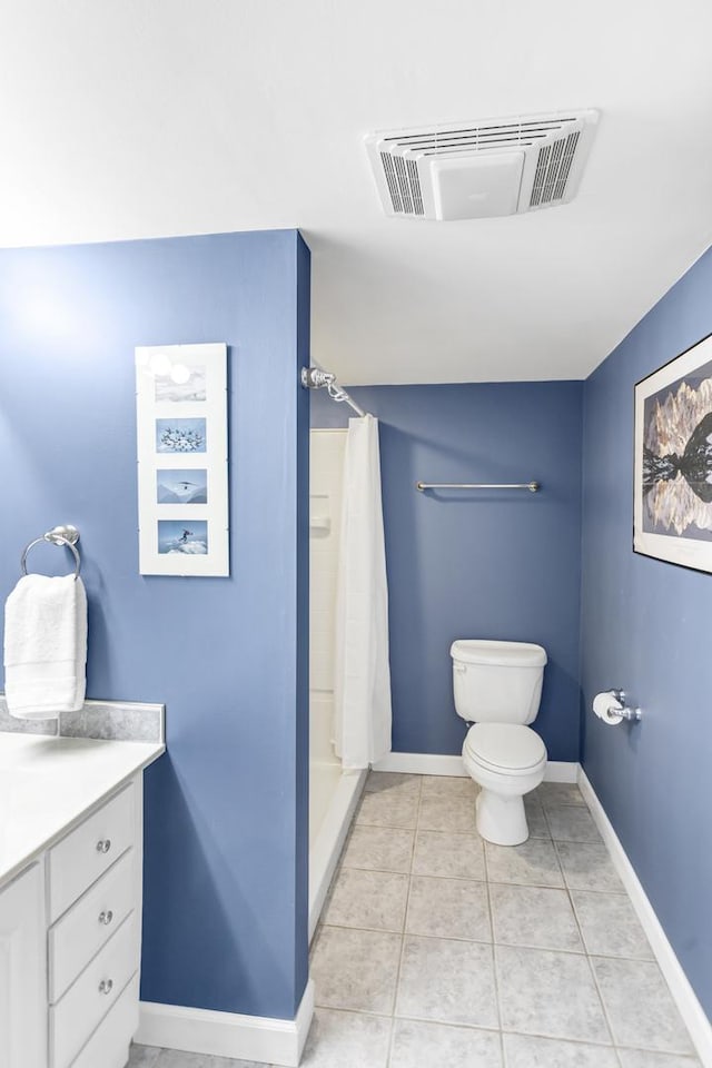 bathroom featuring toilet, walk in shower, vanity, and tile patterned flooring