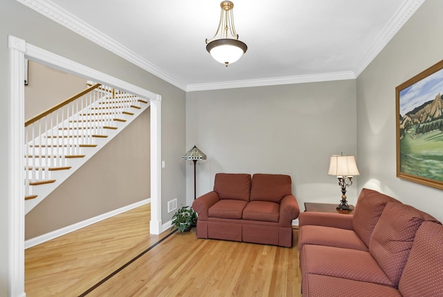 living room featuring wood-type flooring and crown molding