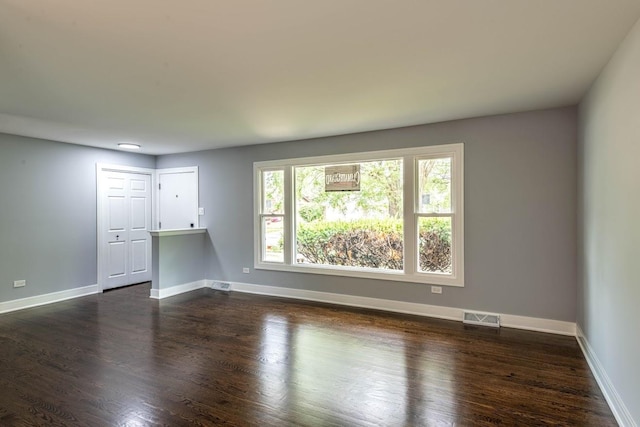 unfurnished living room featuring dark hardwood / wood-style flooring