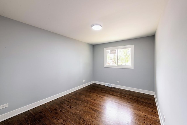 spare room featuring dark hardwood / wood-style floors