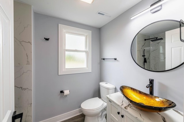 bathroom with a shower, vanity, wood-type flooring, and toilet