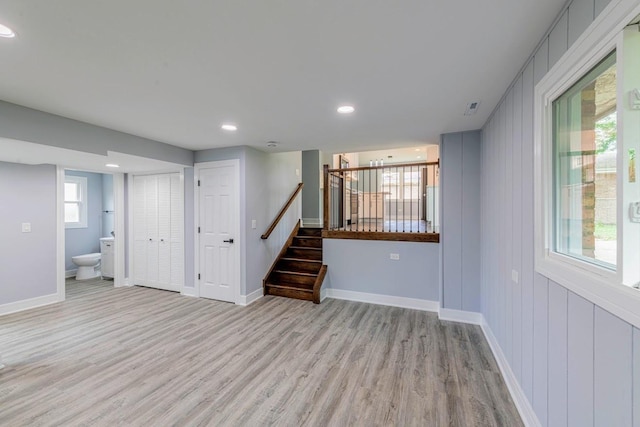 basement with light hardwood / wood-style flooring