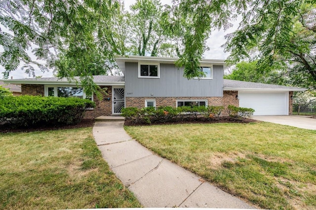 split level home with a front lawn and a garage