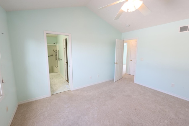 unfurnished bedroom with ceiling fan, ensuite bath, vaulted ceiling, and light carpet