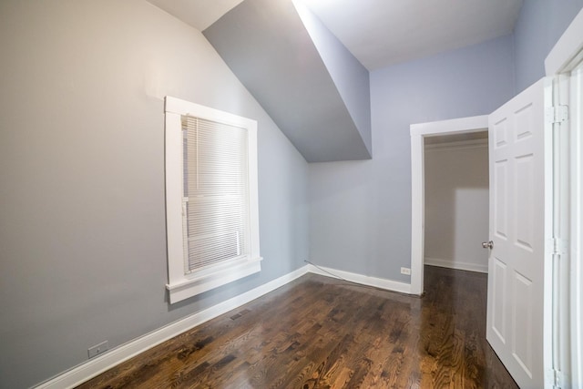 bonus room featuring dark hardwood / wood-style floors and vaulted ceiling